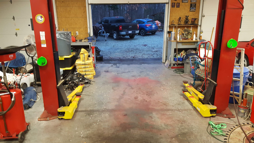 Empty bay in a garage with a lift.