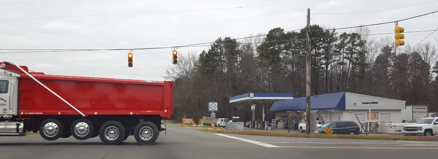 A red truck at the intersection