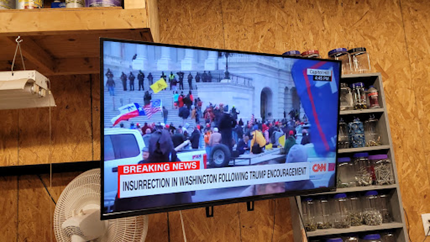 Photo of television screen reporting on DC insurrection, January 6, 2021
