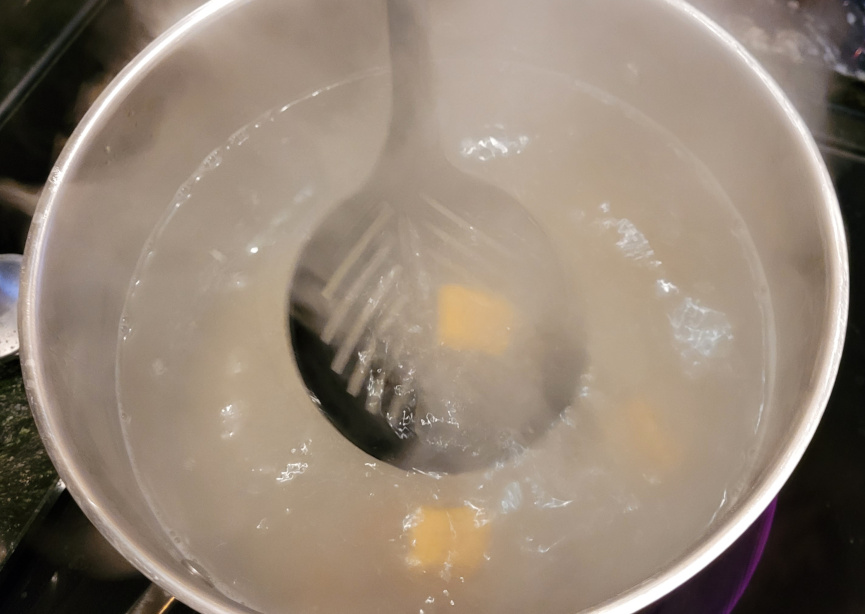 Boiling water in pan with gnocchi
