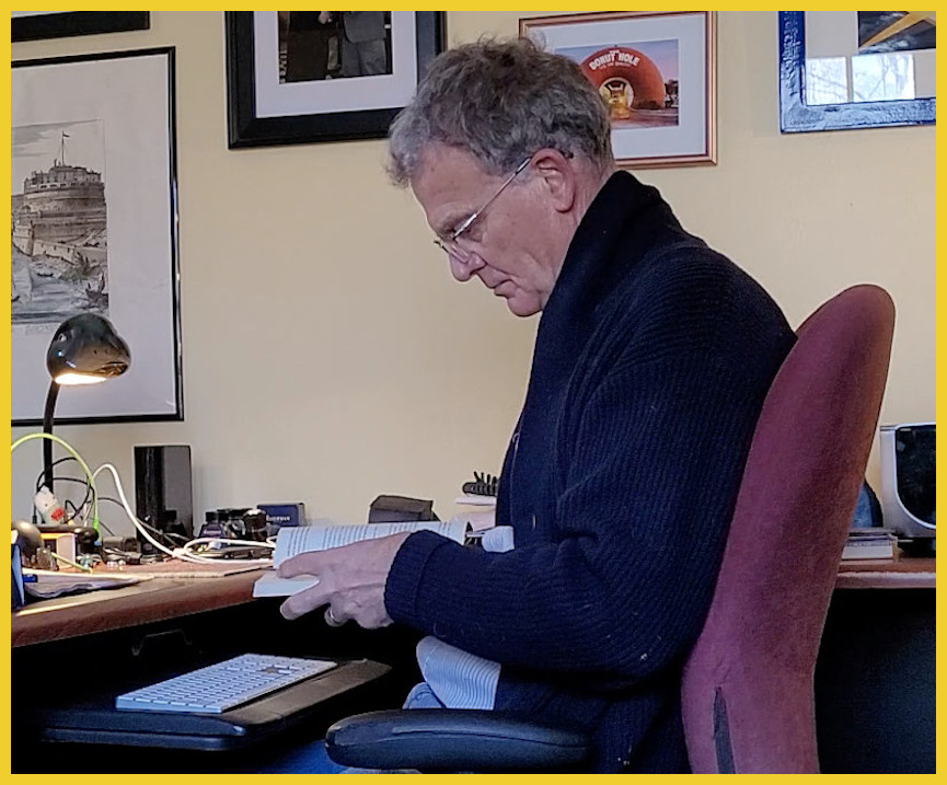 Man looking at a book in his office