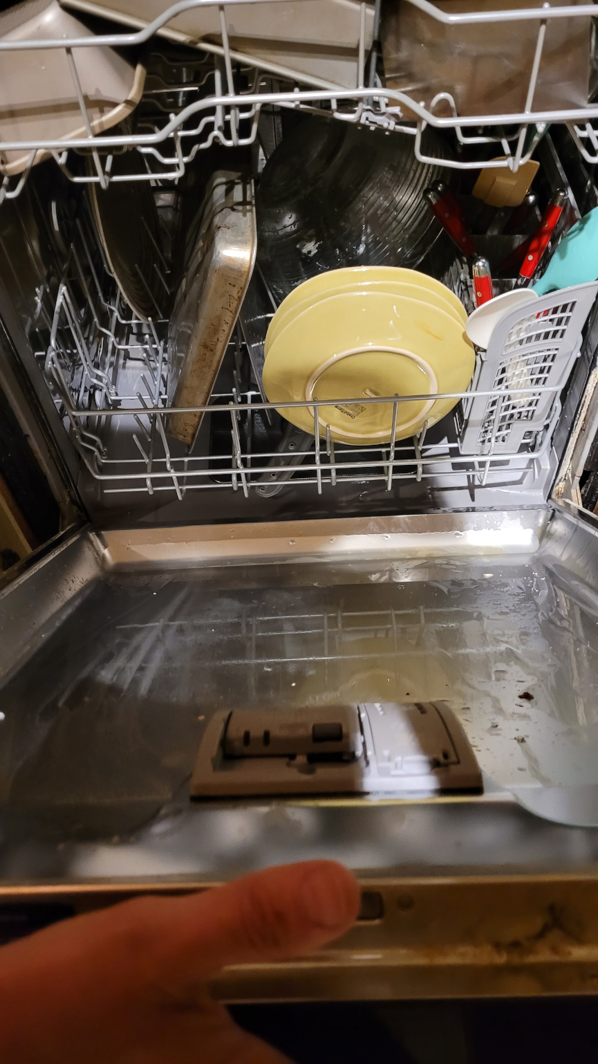 a loaded dishwasher being closed