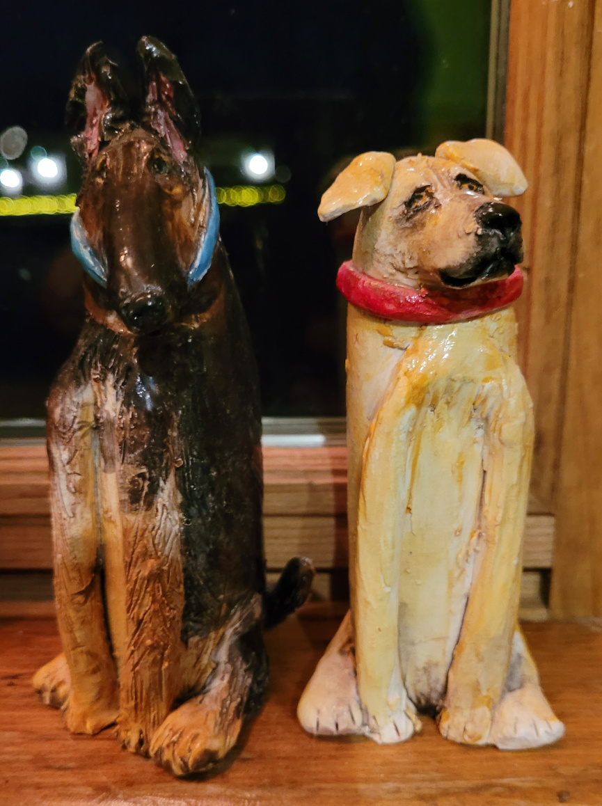 Small statues of two dogs.