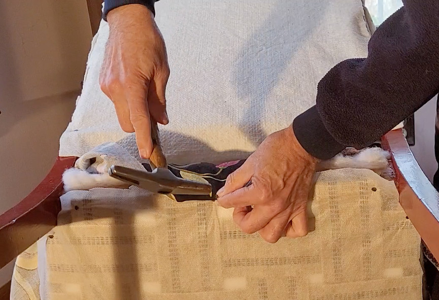 attaching upholstery to a seat cushion on a chair