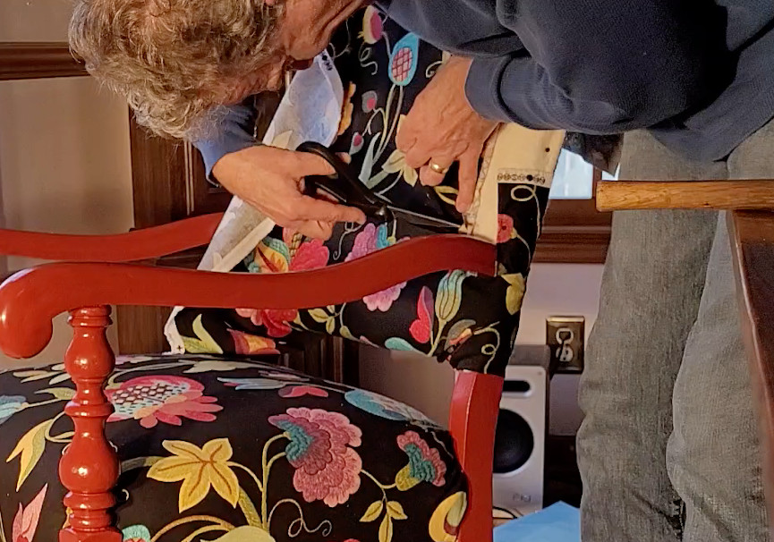 man working on reupholstering a chair