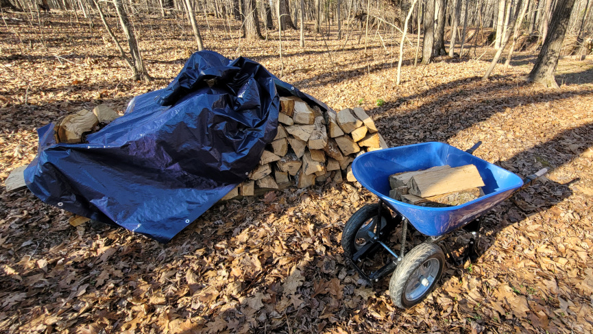firewood stack, partially covered.