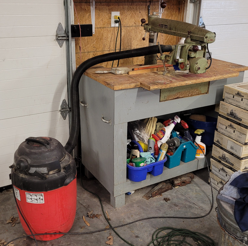 A radial arm saw with sawdust vacuum set up