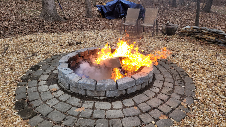a fire pit with cardboard burning