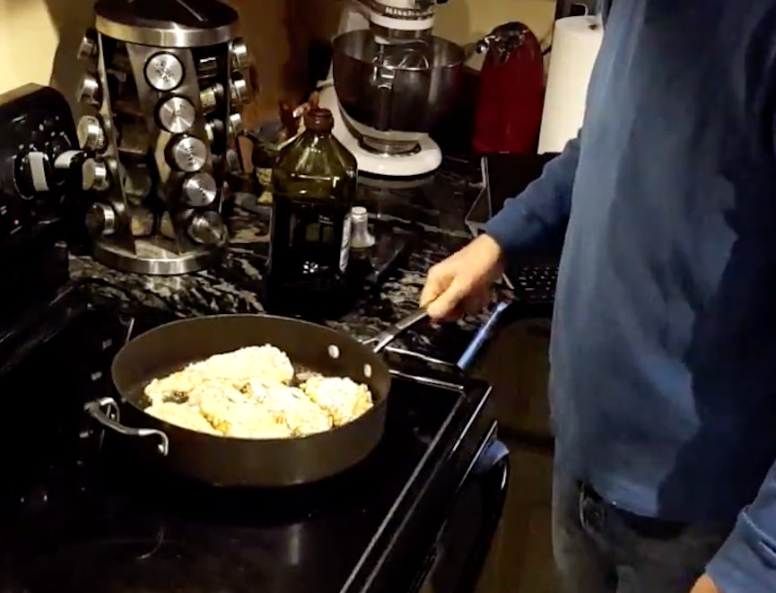 frying chicken breasts on a stove